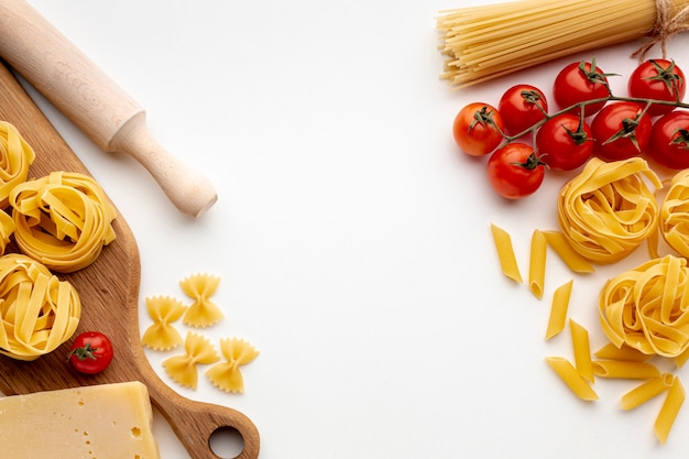 Mix of uncooked pasta with tomatoes and hard cheese