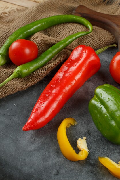 Mixed chili peppers on a piece of burlap. Top view.
