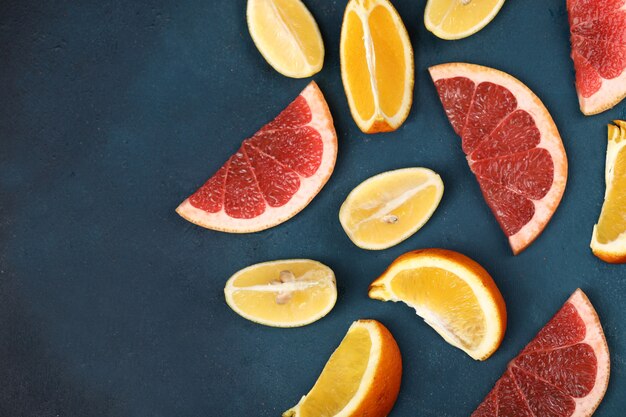 Mixed citrus fruits on blue.