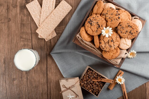 Mixed cookies and coffee beans with cinnamon and crackers