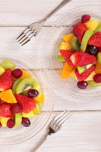 Mixed fresh fruits salad with forks