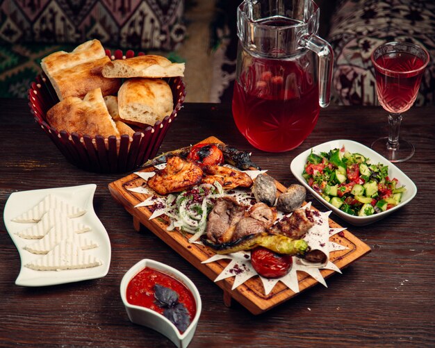 Mixed fried meat with glass of compote