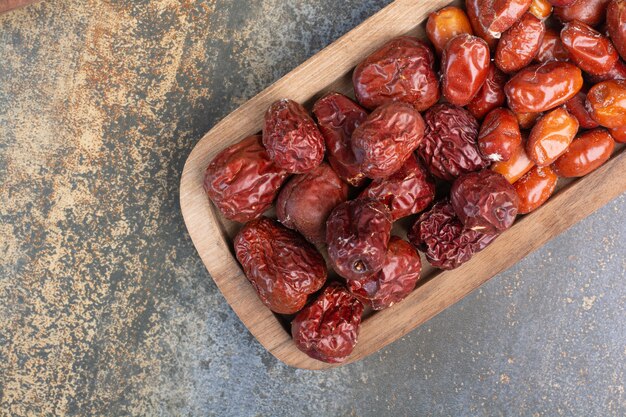 Mixed healthy dried fruits on wooden plate. High quality photo