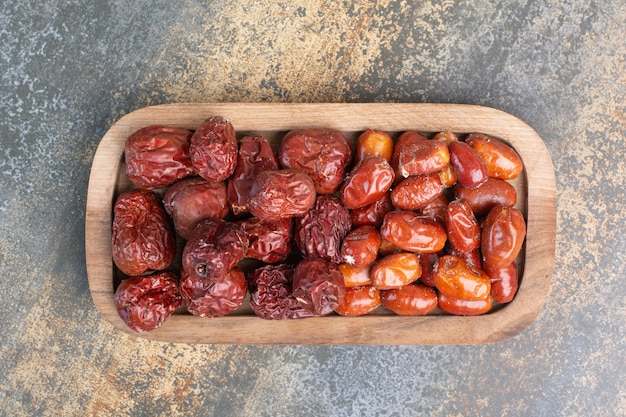mixed healthy dried fruits on wooden plate. high quality photo