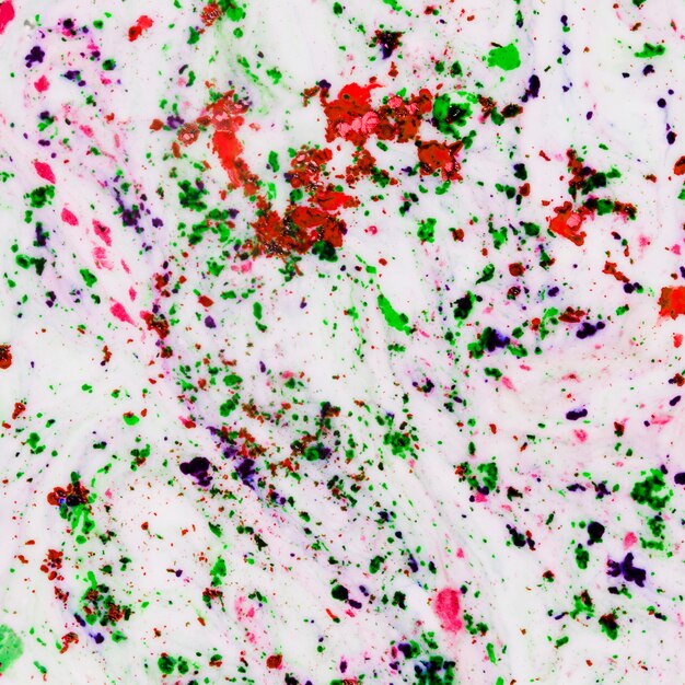 Mixed holi color powder on the white surface