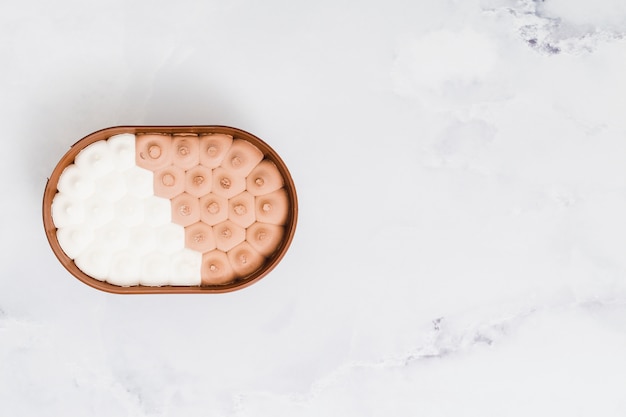 Free photo mixed ice cream in plastic bowl on marble surface