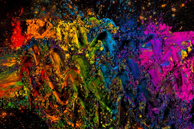 Mixed multicolored dry powder colors on black background