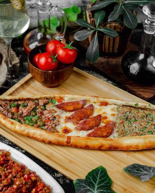 mixed pide filled with sausage, cheese and meat