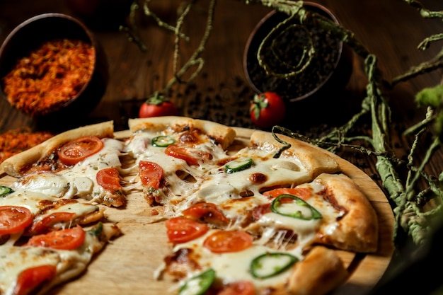 mixed pizza with lots of cheese and tomato