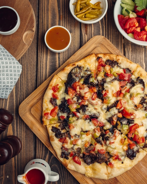 mixed pizza with meat, tomato, bell pepper