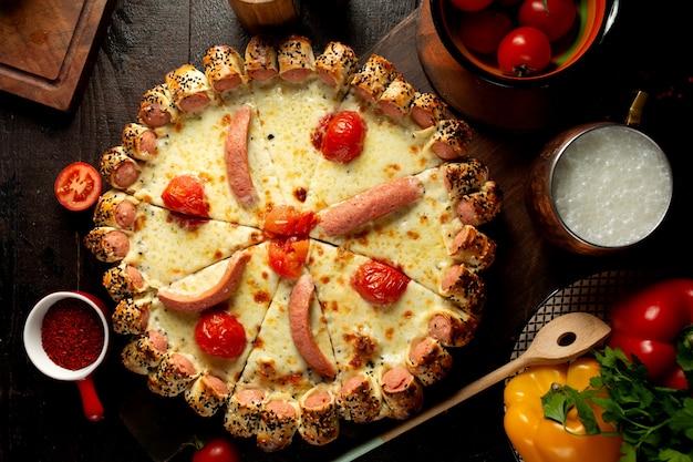 Mixed pizza with tomatoes and sausages