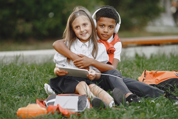 Mixed-races boy and little girl in park