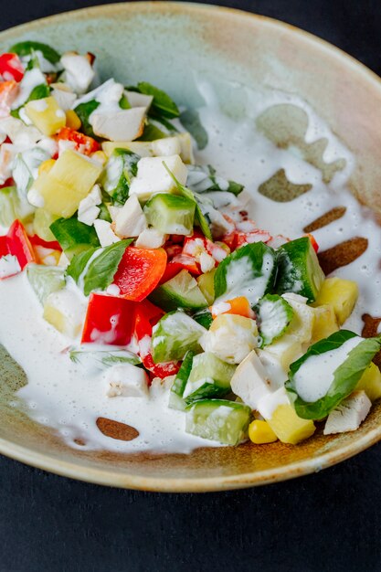 Mixed salad prepared with vegetables sauce and greens