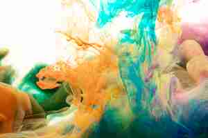 Free photo mixing splashes of paint