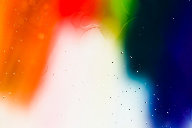 Mixing water and oil on a coloured liquid abstract background 