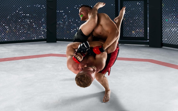 Free photo mma fighters on professional ring fighting championship