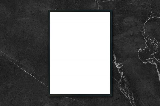 Mock up blank poster picture frame hanging on black marble wall in room