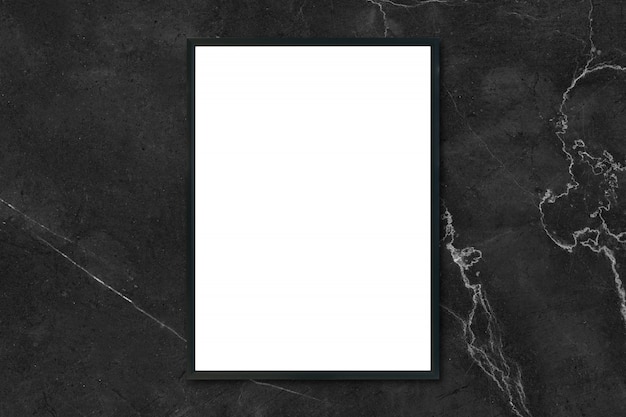 Mock up blank poster picture frame hanging on black marble wall in room