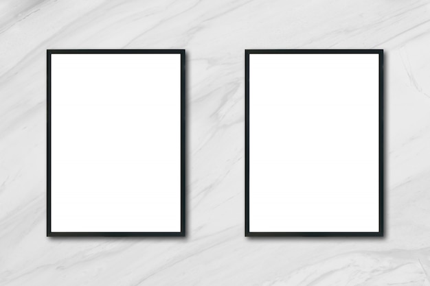 Mock up blank poster picture frame hanging on white marble wall in room - can be used mockup for montage products display and design key visual layout.