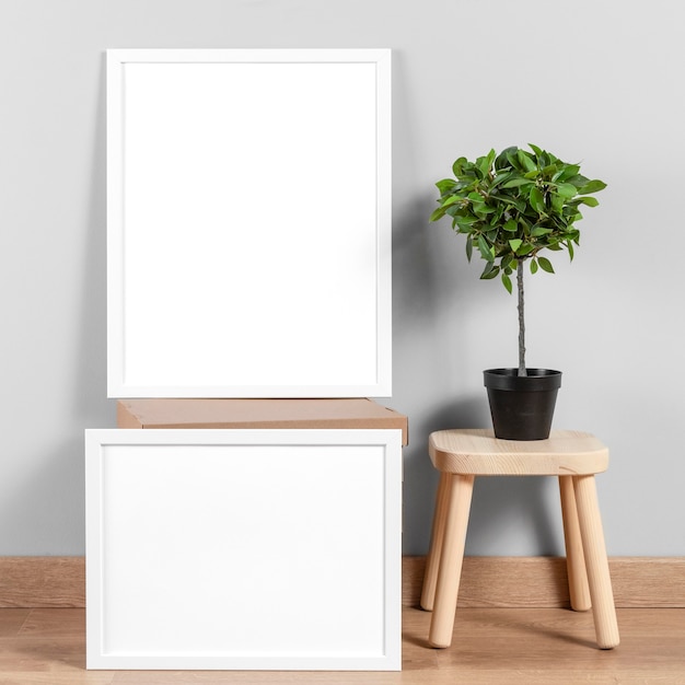 Free photo mock up frames beside chair