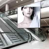 Free photo mock up of a photo frame with a portrait of a young woman on the escalator