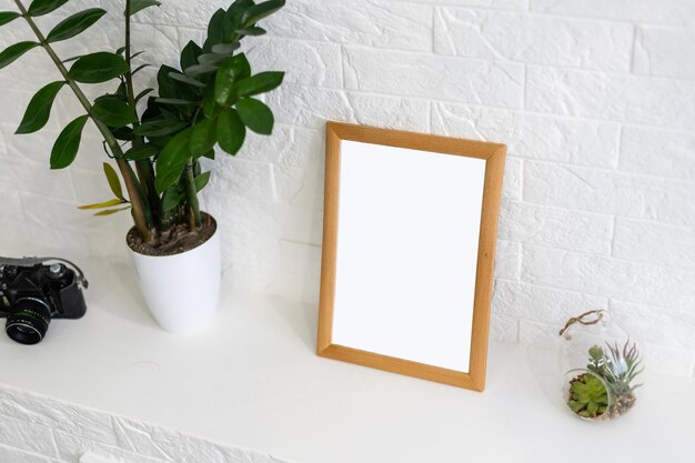 Mock up white frame and vase on book shelf or desk. white colors.