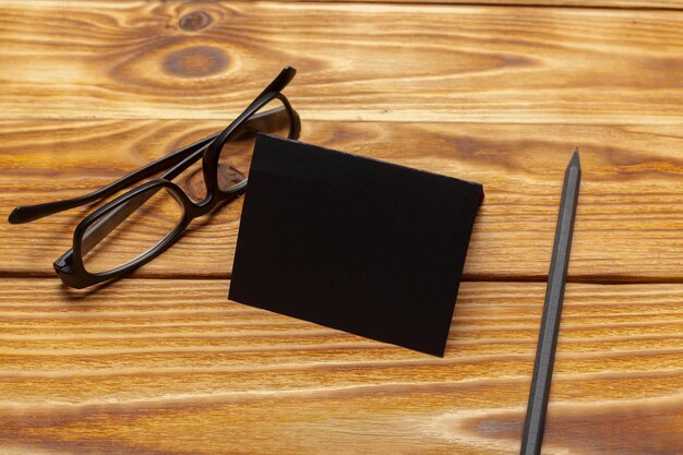 Mockup of black paper on wooden table