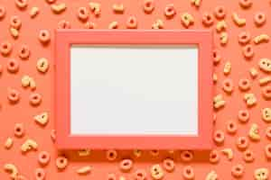 Free photo mockup blank frame and breakfast cereals on colored surface