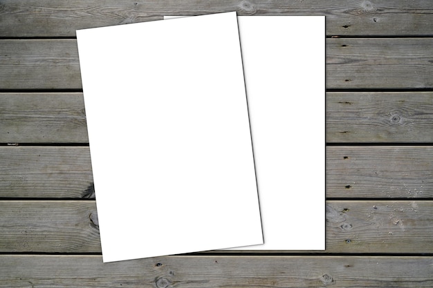 Mockup blank two white paper and space for text on old wooden plank background