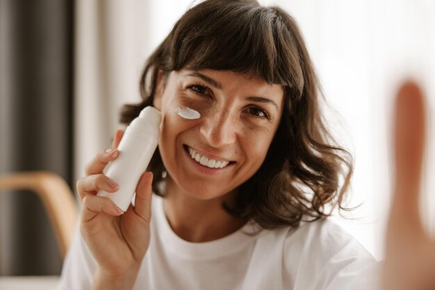 Mockup of cosmetics for woman products doing selfie