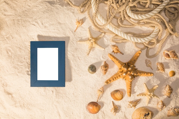 Mockup with blank frame and seashells