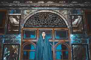 Free photo model in blue dress in a historical mosque