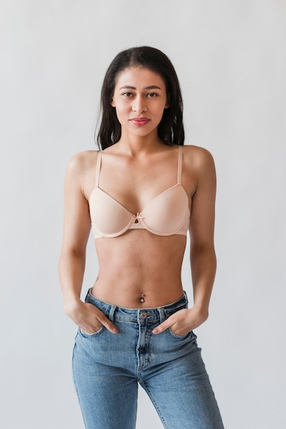 Model in bra standing with hands in pockets