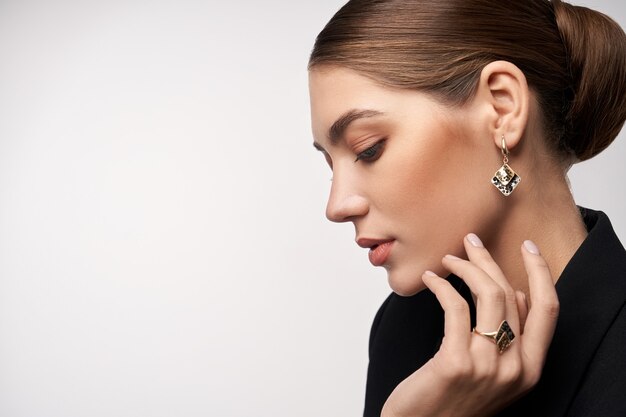Model demonstrating earrings and ring