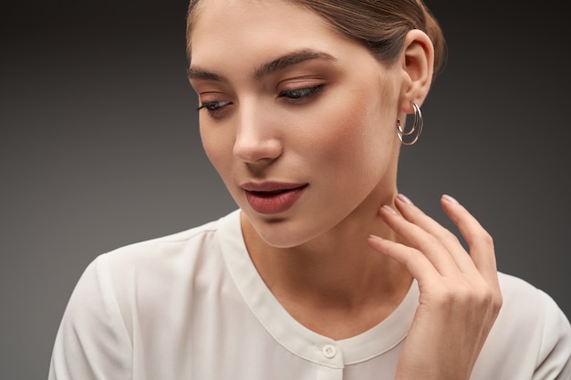 Model demonstrating silver earrings