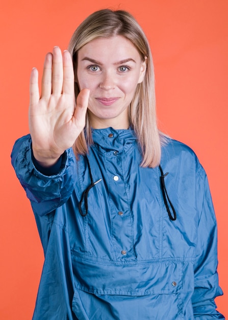 Free photo model doing stop gesture front view