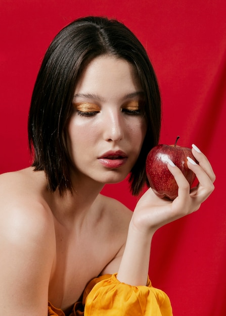 Model holding an apple close up