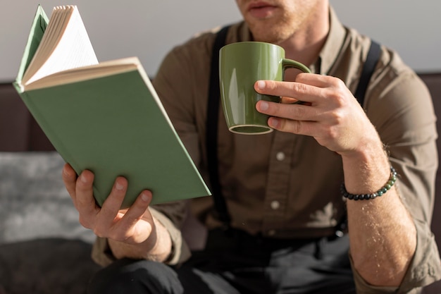 Model holding cup of coffee and reads