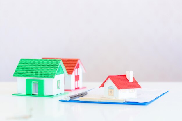 Model of house painted white under the tiled roof on white