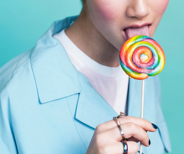 Free photo model licking multicolored lollipop