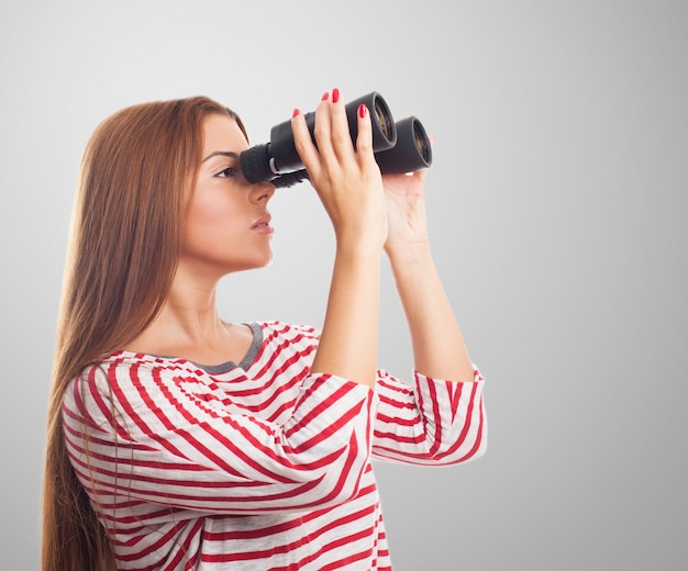 Model looking through binoculars