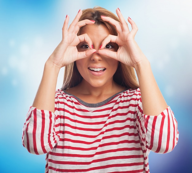 Model looking through hand binoculars