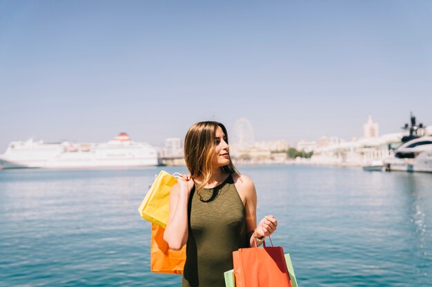 Model posing at the seaside after shopping