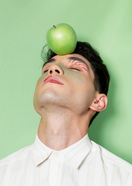 Model posing with apple medium shot