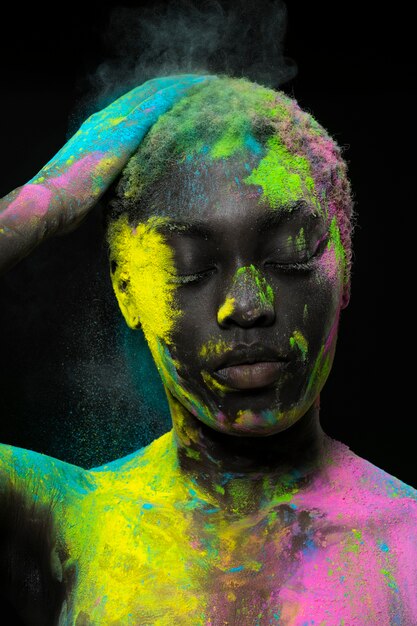Model posing with colorful powder