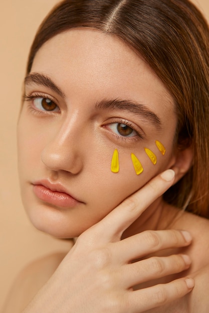 Model posing with yellow petals close up