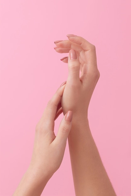 Model's hands with pink background