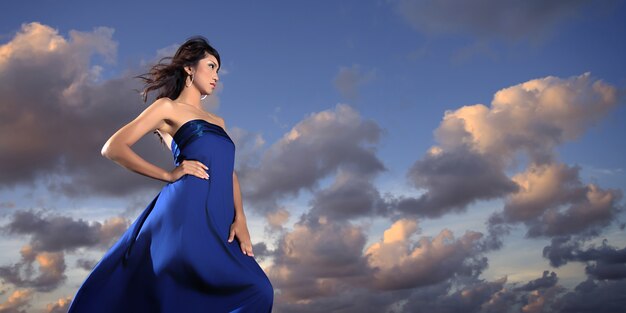 Model with a blue dress posing