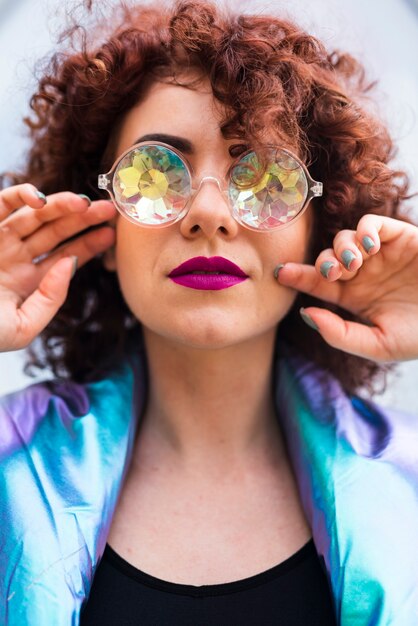 Model with curly hair and glasses