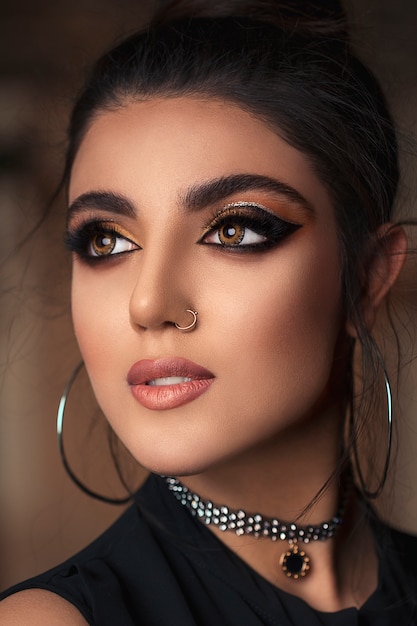 Model with smokey eyes and golden circle earrings